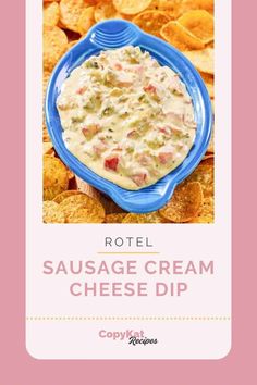 a blue bowl filled with cheese dip surrounded by chips and tortilla chips on a pink background