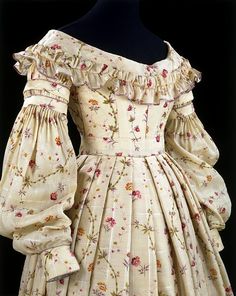 Day Dress, 1837-1840. | V Museum. This 1830s day dress is made of challis printed with a realistic design of wild strawberries, bamboo, pinks and anemones. In the nineteenth century a fascination with flowers in printed textile design was nothing new, but during the 1830s it received a new impetus. Technical improvements to the printing process and advances in dye chemistry meant that floral prints could be mass-produced at low prices.