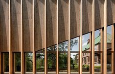 the side of a building with wooden slats on it's sides and windows