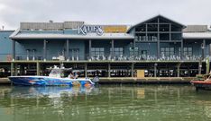 two boats are docked in front of a restaurant