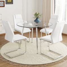 a glass table with white chairs around it