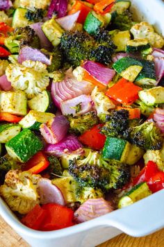 a casserole dish with broccoli, cauliflower and other vegetables