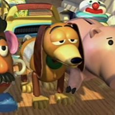 two cartoon dogs are standing next to each other in front of a table with food on it