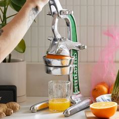 someone is using a juicer to make orange juice