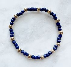 7’ bracelet. Dark blue 4mm seed beads and gold plated beads. Beaded Bracelets Designs Inspiration, Blue And Gold Beaded Bracelets, Dark Blue Beaded Necklace, Adjustable Beaded Yellow Gold Stretch Bracelet, Handmade Gold Beads For Everyday, Everyday Handmade Gold Beads, Dainty Blue Round Bead Bracelets, Blue Beaded Bracelets With Gold Beads, Adjustable Blue Bracelets With Gold Beads