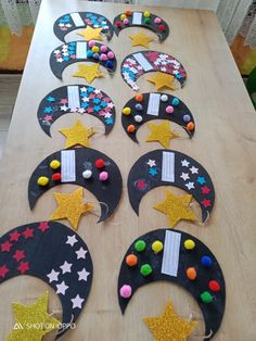 a wooden table topped with lots of decorated crescents and stars on top of it