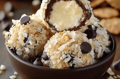 a bowl filled with chocolate and coconut covered desserts