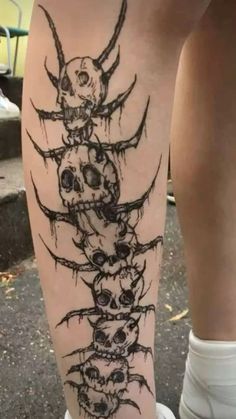 a woman's leg with skulls and bones on it