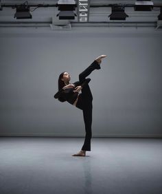 a woman is doing an acrobatic dance pose