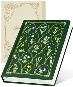 a green book with embroidered flowers on it