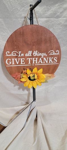 a wooden sign that says, in all things give thanks with sunflowers on it