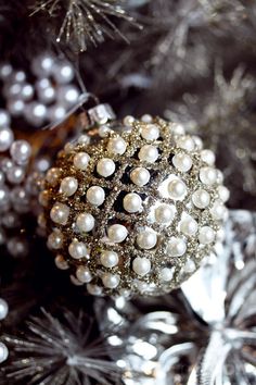 a christmas ornament on top of a silver tree