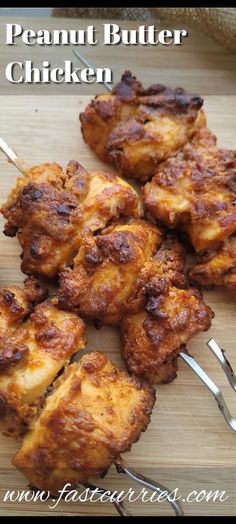 some chicken skewers are sitting on a cutting board with the words, peanut butter chicken