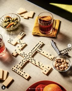 a table topped with lots of different types of food and drinks on top of it