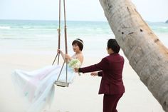 a bride and groom on the beach getting ready for their wedding ceremony at the ocean