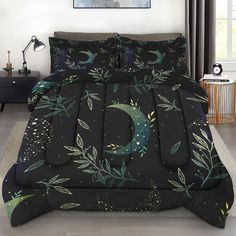 a black bed with green leaves and a crescent on it