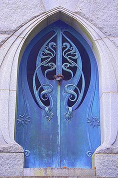 an ornate blue door is shown in front of a building