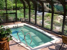 a large indoor swimming pool in the middle of a patio