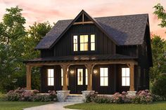 a black and brown house with two windows