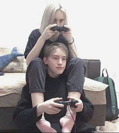 two people sitting on the floor playing video games