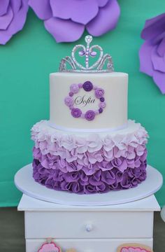 a white and purple cake sitting on top of a table