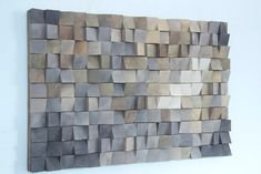 a wall sculpture made out of wood blocks