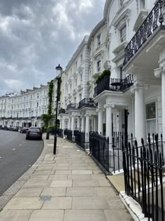 a row of white houses with black balconies