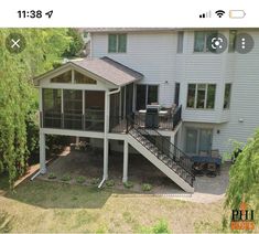 an aerial view of a house with a deck on the front and second story in the back