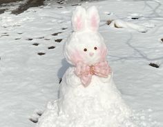 a snowman made to look like a bunny with a pink bow