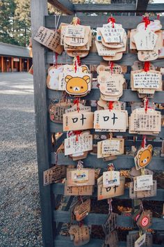 wooden signs with japanese characters hanging from them