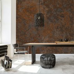 a dining room table and chairs in front of a wall with a large stone pattern