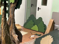 a room with cardboard trees and other items on the floor