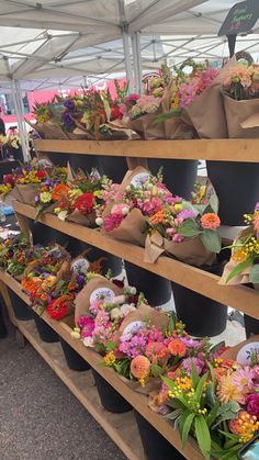 flowers are on display at an outdoor market