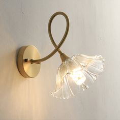 a light that is on the side of a wall with a lamp attached to it