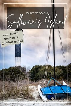 a blue boat sitting on top of a sandy beach next to a sign that says, what to do on sullivan's island