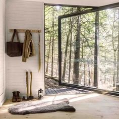 an open door leading into a forest filled with lots of trees and tools on the floor