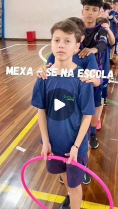 young boys are standing in a gym holding hoops and looking at the camera with words over them