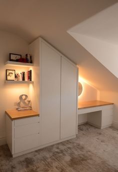 an attic bedroom with built - in bookshelves and shelves