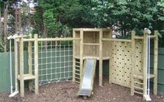 a wooden play structure with a slide in the middle