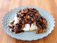 a plate topped with ice cream covered in nuts