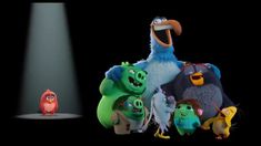 the angry birds are standing next to each other in front of a spotlight on a black background