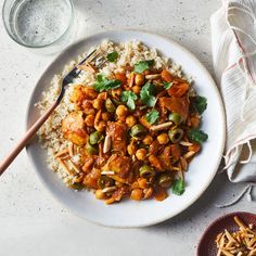 a white plate topped with rice and vegetables