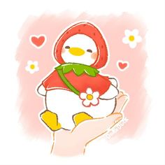 a hand holding a small white penguin with a red scarf on it's head