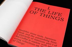 an open red book with black writing on the front and back cover that reads, 1 the life of things