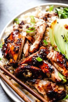 chicken and rice with chopsticks on a plate