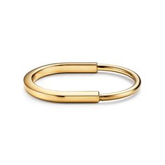 Tiffany Lock is an expression of love’s enduring protection, inspired by a padlock from The Tiffany Archives that dates to 1883. Designed to keep safe that which is cherished, Lock is a universal symbol of what matters most. This style is expertly crafted in 18k yellow gold. How to Open and Close a Tiffany Lock Bracelet: 1. Locate the notch indicated by a small indent. The notch is only on one side of the bracelet. 2. Gently pull outward from either side of the notch. The bracelet will swivel op Tiffany Lock Bracelet, Bridal Jewelry Bracelets, Lock Bracelet, Tiffany Blue Box, Lock Jewelry, Tiffany Bracelets, Stackable Bangles, The Bangles, Jewelry Bracelets Gold