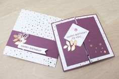 two purple and white greeting cards with gold foil flowers on them, one has a happy birthday card attached to it