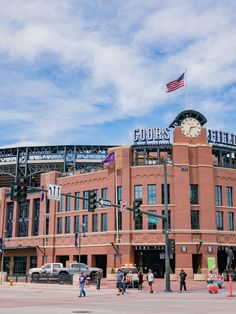 a baseball stadium with people walking around it