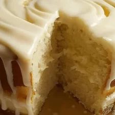 a close up of a cake with white frosting