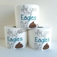 three rolls of toilet paper with the words on them and an eagle's play like sticker